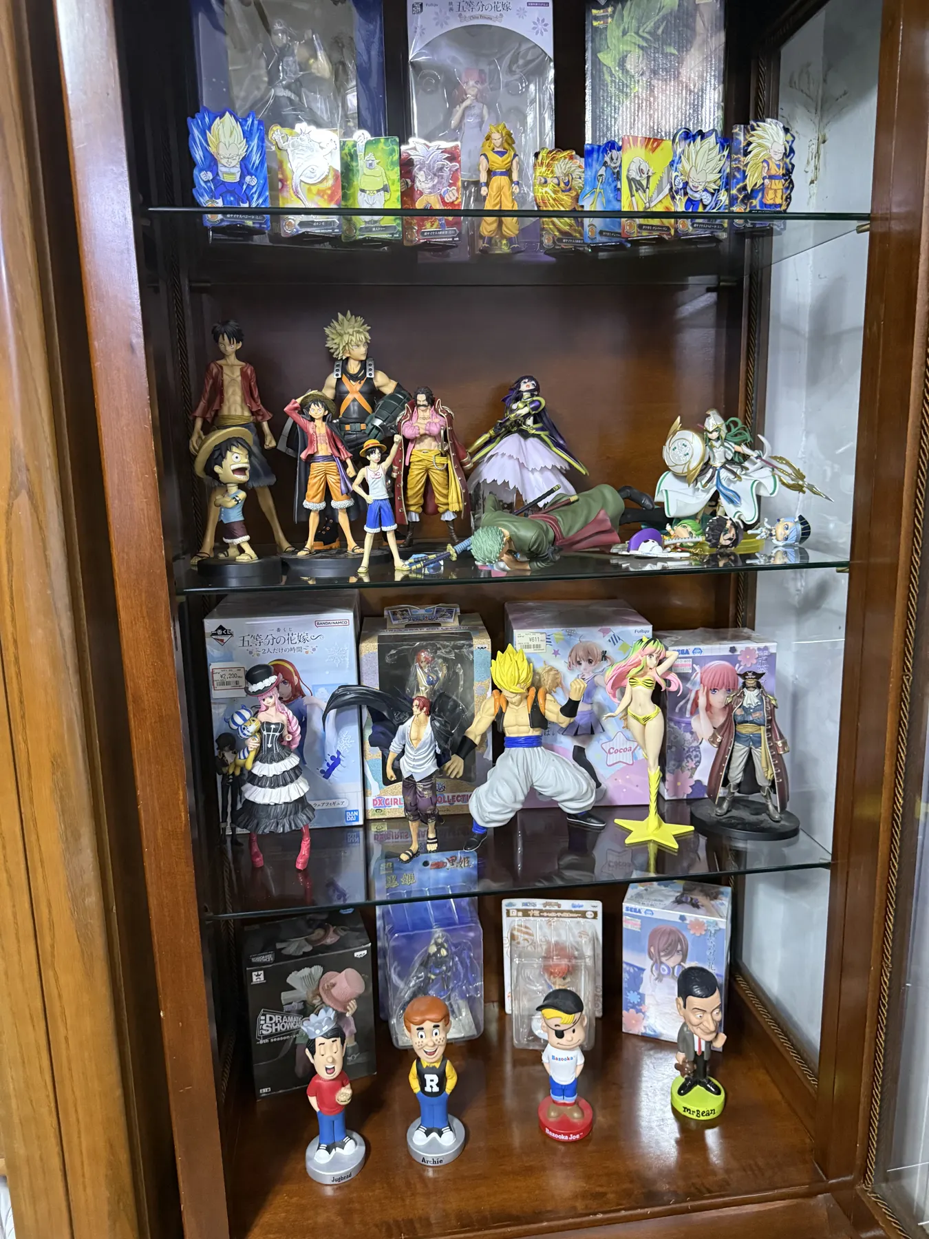 Glass cabinet filled with boxed anime figures
