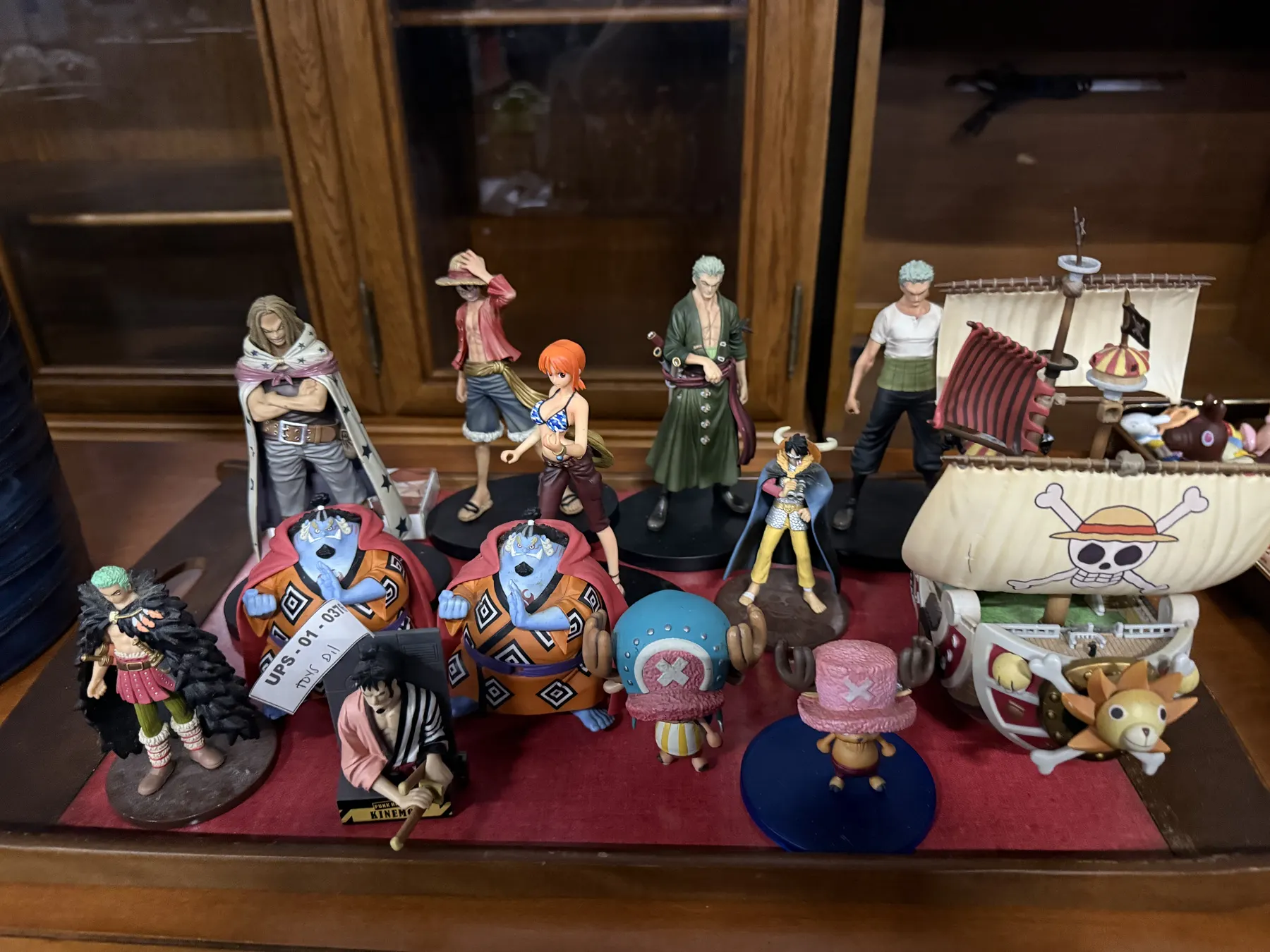 Display of One Piece anime figures and a Going Merry ship