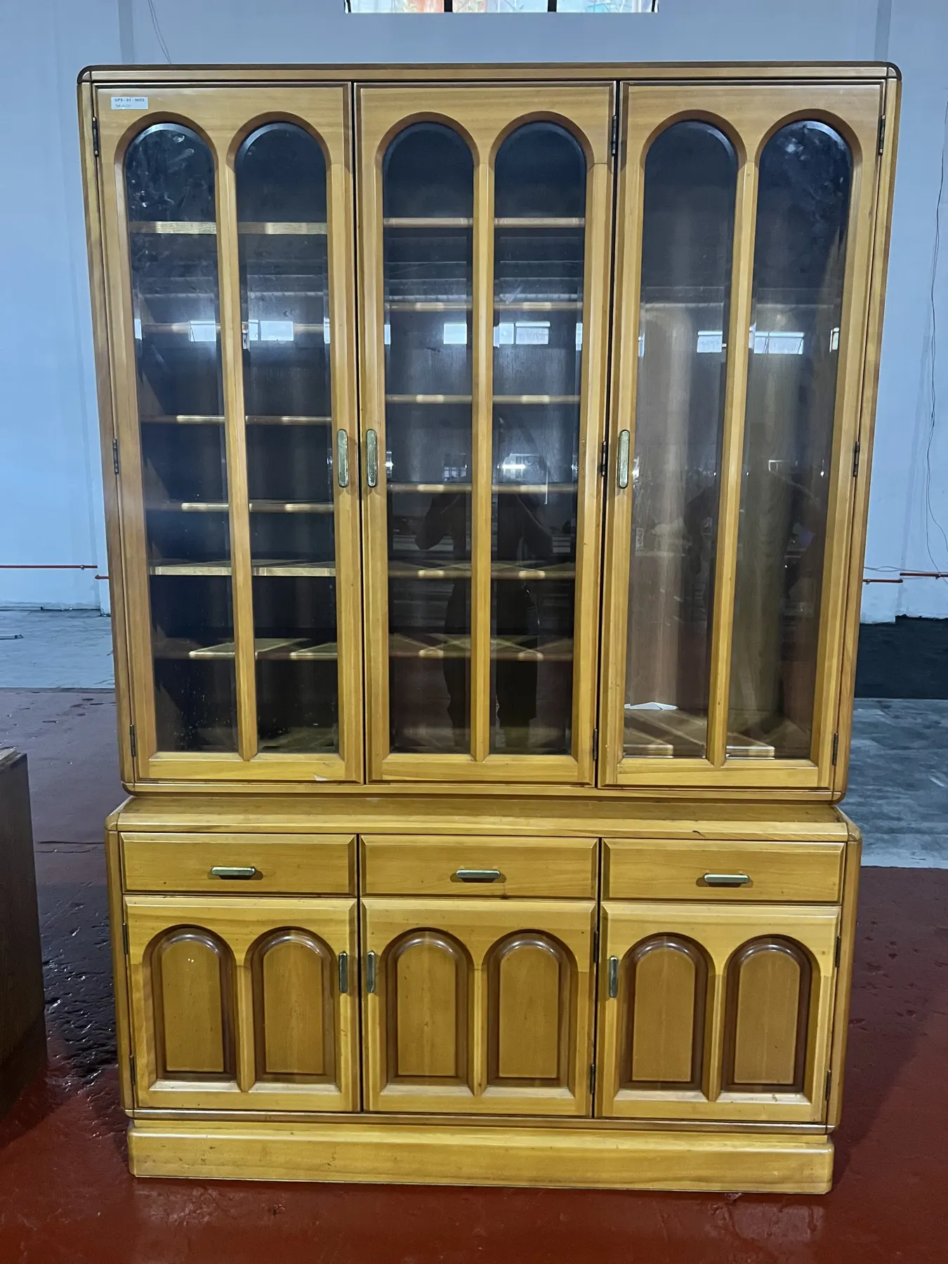 Golden oak display cabinet with arched glass doors
