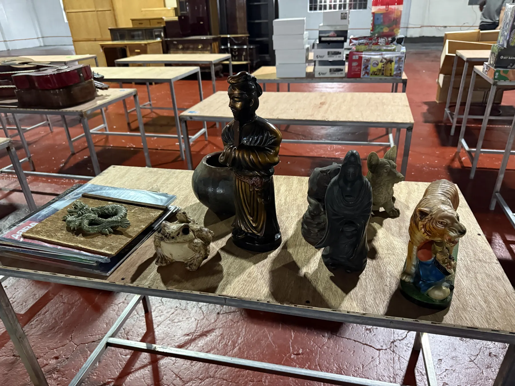 Bronze figure, dragon tray and tiger figurine on a display table